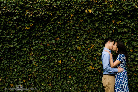 engaged couple kissing against the ivy during their Princeton University engagement session