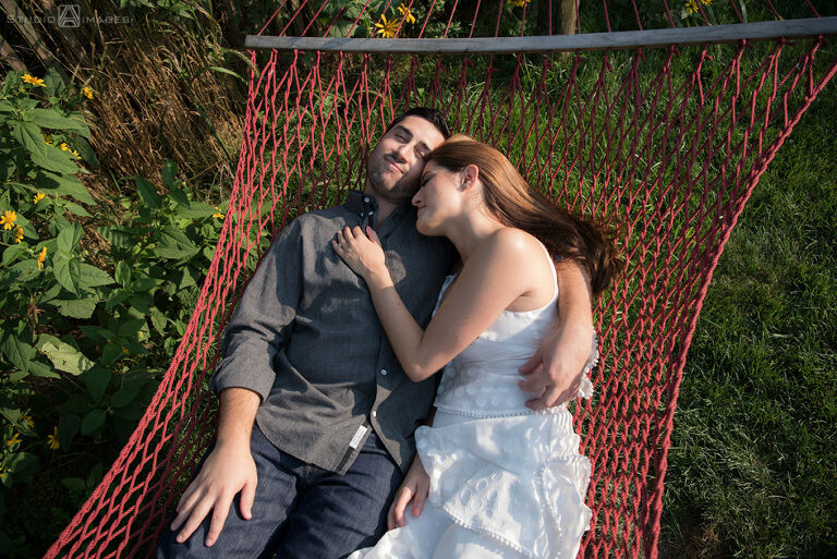 couple posing for their engagement photos on the hammocks at Governors Island