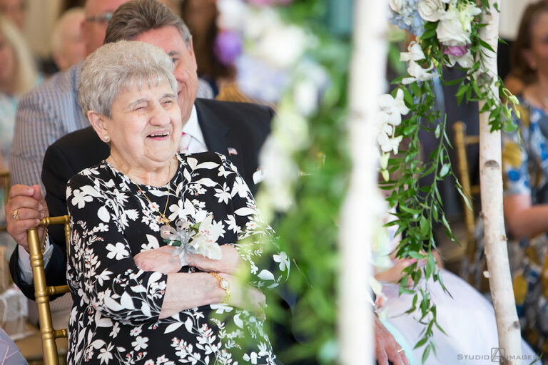 grandma laughing during  ceremony on wedding day at The Rockleigh | Book Inspired Wedding Photos | Book Themed Wedding Photos | LGBTQ wedding