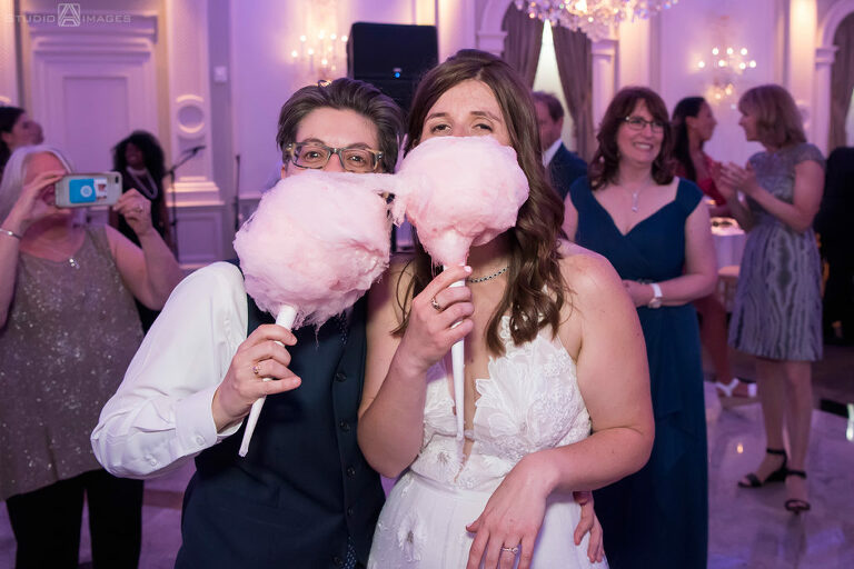 brides with cotton candy on their wedding day at The Rockleigh | Book Inspired Wedding Photos | Book Themed Wedding Photos | LGBTQ wedding