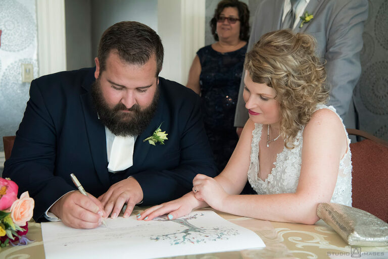 bride and groom sign ketubah on wedding day at Pen Ryn Estate | Pen Ryn Estate Wedding Photos | Bucks County Wedding Photographer