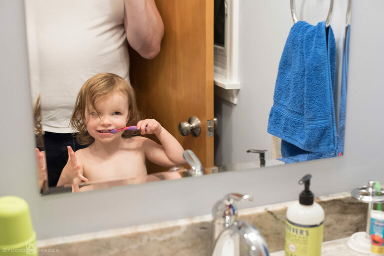 parents and daughter at bath time during their Documentary-style day in the life family photo shoot