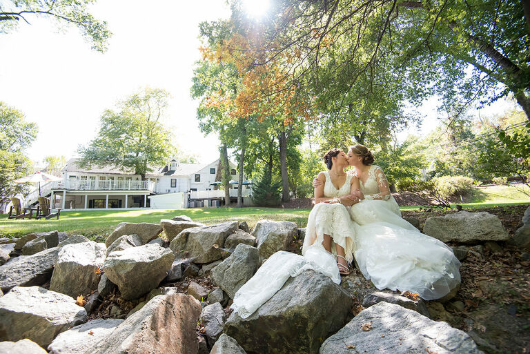 brides kissing on wedding day at Grain House in Basking Ridge