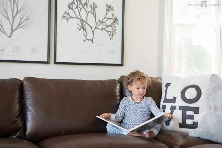 Long Island family photos of son reading on couch
