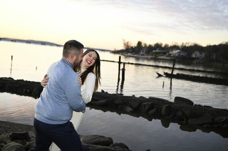 couple laughing at dawn during their sunrise engagement session in Nyack