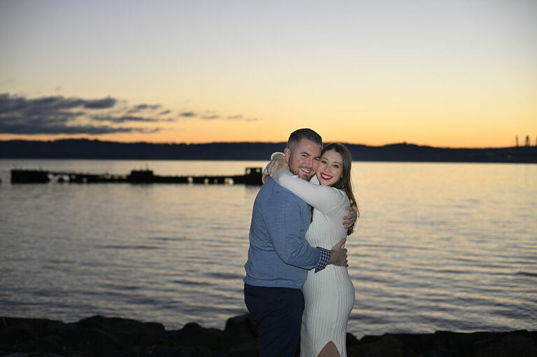couple smiling at dawn during their sunrise engagement session in Nyack