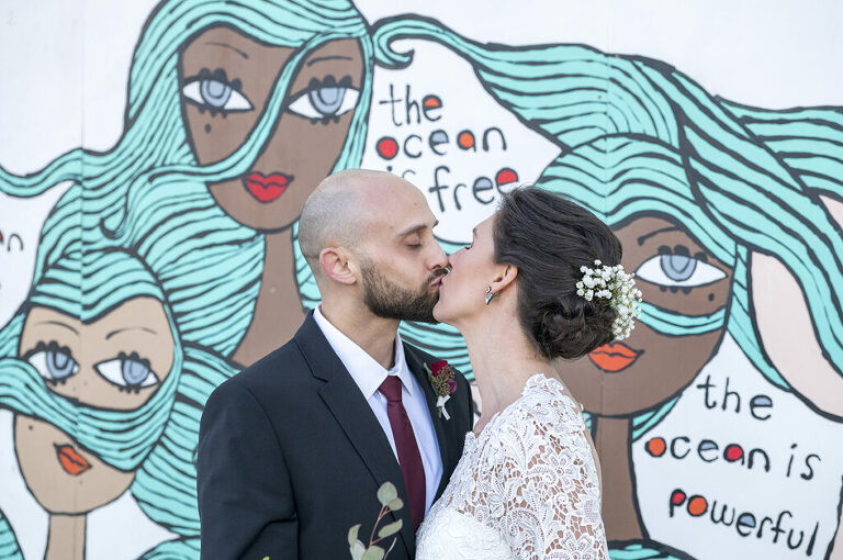 bride and groom in front of Asbury Park murals on their wedding day in Asbury Park.