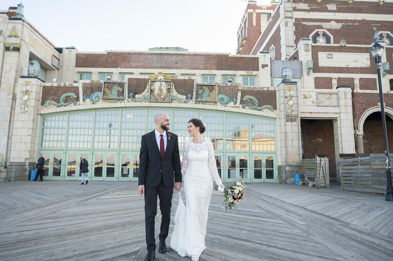 bride and groom in front of Asbury Park Convention Hall on their wedding day in Asbury Park.