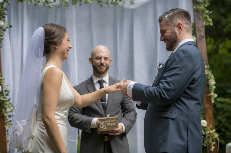 bride and groom exchanging rings on their wedding day in New York
