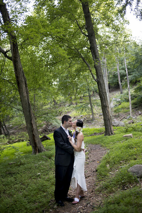 bride and groom kissing at Bear Mountain on their wedding day