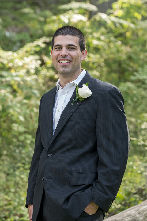 groom posing for a portrait on their wedding day at Bear Mountain in Hudson Valley