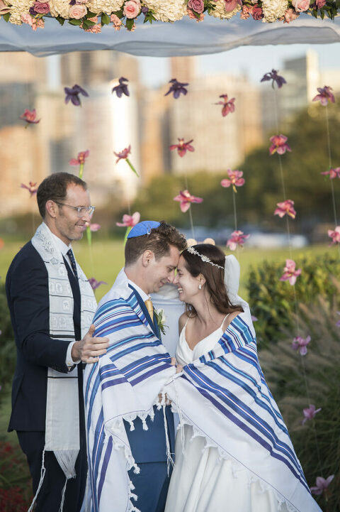 bride and groom wrapped in a tallis during a Jewish wedding ceremony at Liberty House in Jersey City