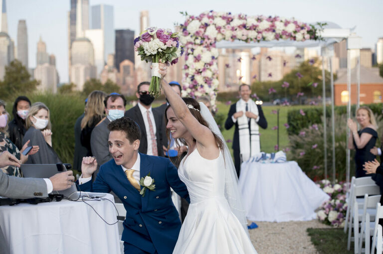 bride and groom say hello to zoom guests after the conclusion of their wedding ceremony at Liberty House in Jersey City