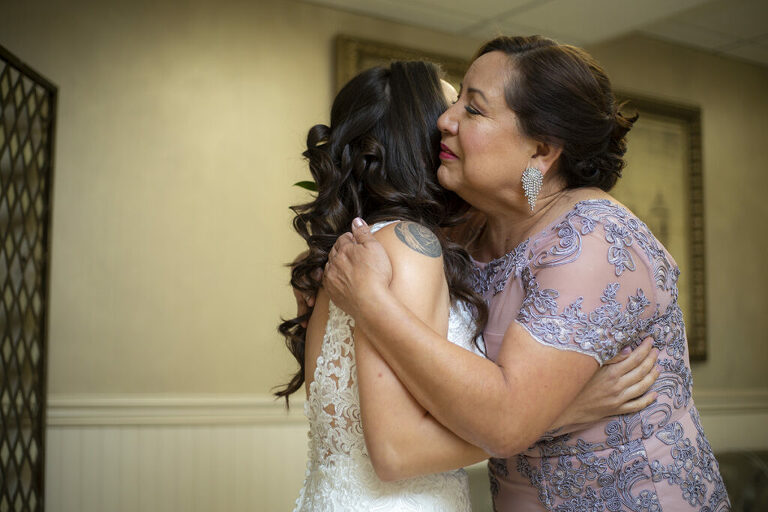 bride and her mom sharing a moment on wedding day at Windows on the Water at Frogbridge. LGBTQ wedding