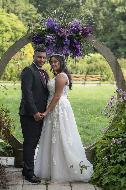 bride and groom pose for portraits after their intimate Queens Botanical Garden wedding