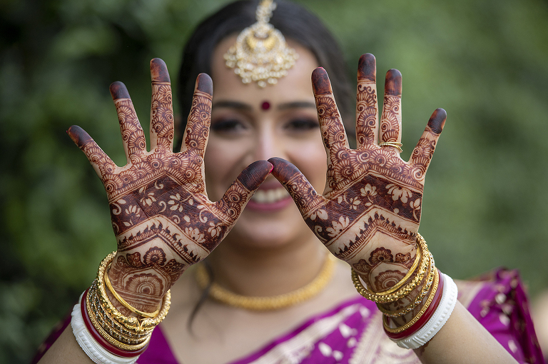 Indian bride showing off her henna on her wedding day at Glen Ridge Women’s Club