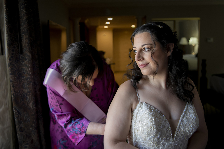bride getting into her dress on wedding day at Conservatory at The Madison Hotel Wedding in Morristown, NJ