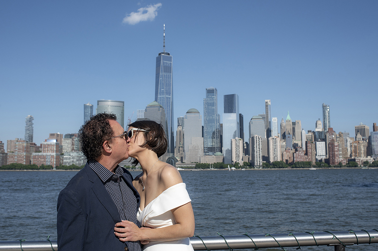 bride and groom with NYC skyline at Jersey City elopement