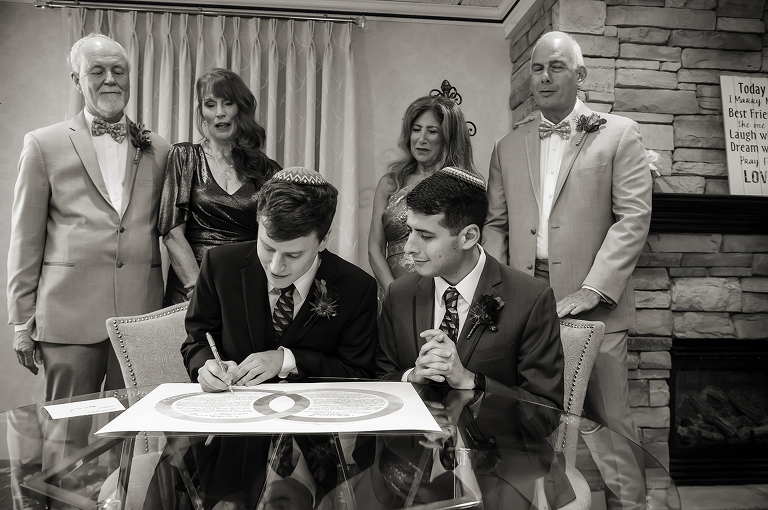 grooms signing ketubah on wedding day at The English Manor. LGBTQ wedding