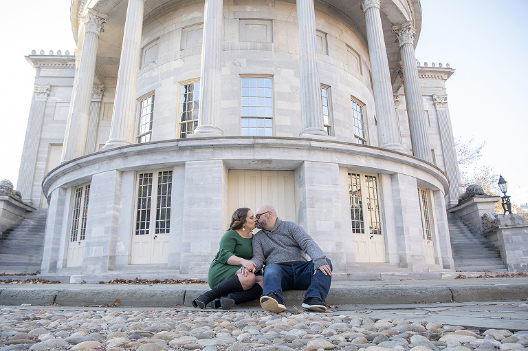 couple posing at Merchant Exchange Building in Philadelphia for their Old City Philly engagement session