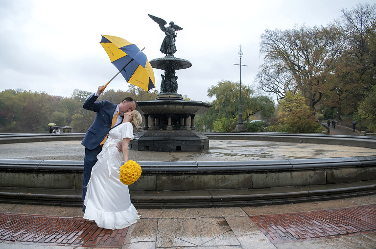 couple kissing in the rain after their wedding ceremony in Central Park