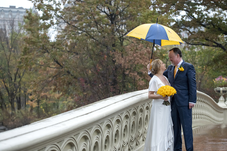 bride and groom in rain on their wedding day in Central Park, NYC