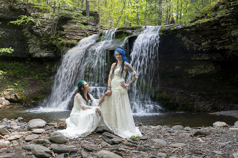 Pagan-Nordic-Themed brides in front of waterfall at their Catskills Wedding