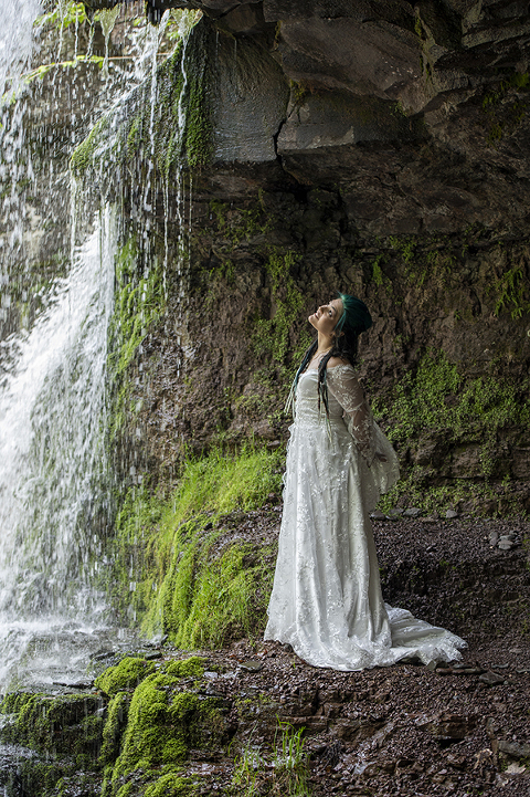 brides at waterfall in the forest on their wedding day at Riedlbauer’s Resort in the Catskills. LGBTQ wedding