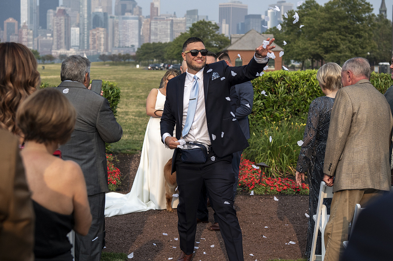 flower man at wedding ceremony with NYC skyline at Liberty House in Jersey City