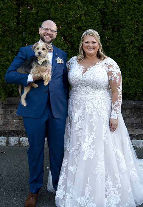 bride and groom with their dog at fall wedding at Stone House at Stirling Ridge