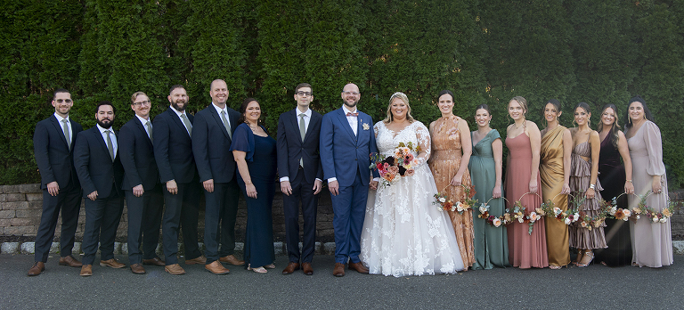 bride and groom with their wedding party at fall wedding at Stone House at Stirling Ridge