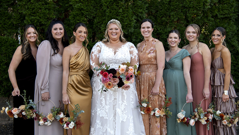 bride with their wedding party at fall wedding at Stone House at Stirling Ridge