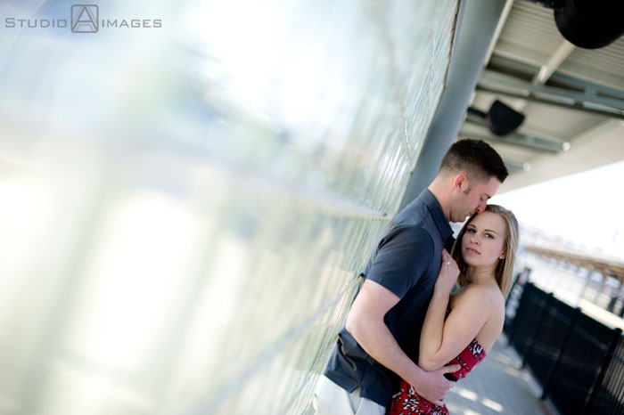 cute couple holding one another at train station, Couples, Engagement, Bayonne, Magic Fountain Ice Cream, Hoboken, Love, NJ, NJ wedding photography, Photography, Portraits, Studio A Images, wedding photography, engagement photography