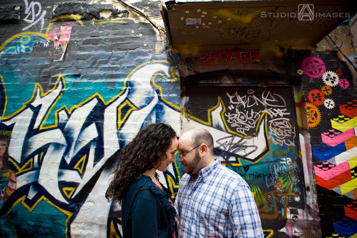 Cambridge, graffiti, Couples, Engagement, engagement photography, engagement photos, Love, MA, Massachusetts, Massachusetts wedding photography, Photography, Portraits, Studio A Images, wedding photography, Massachusetts engagement photos, Cambridge engagement photos, rainy day photos, umbrellas