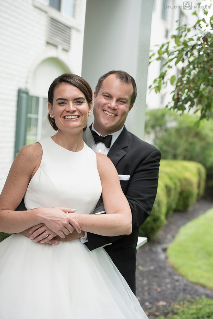 Bride and groom smiling on their wedding day at The Madison Hotel in Morristown. 