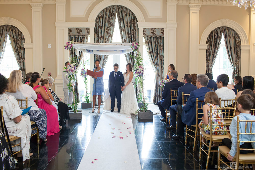 brides at ceremony on wedding day at The Rockleigh | Book Inspired Wedding Photos | Book Themed Wedding Photos | LGBTQ wedding