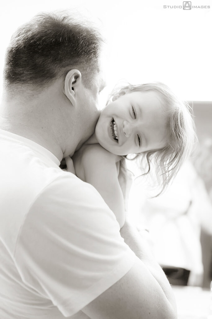 parents and daughter at bath time during their Documentary-style day in the life family photo shoot