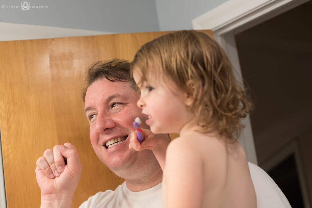 parents and daughter at bath time during their Documentary-style day in the life family photo shoot