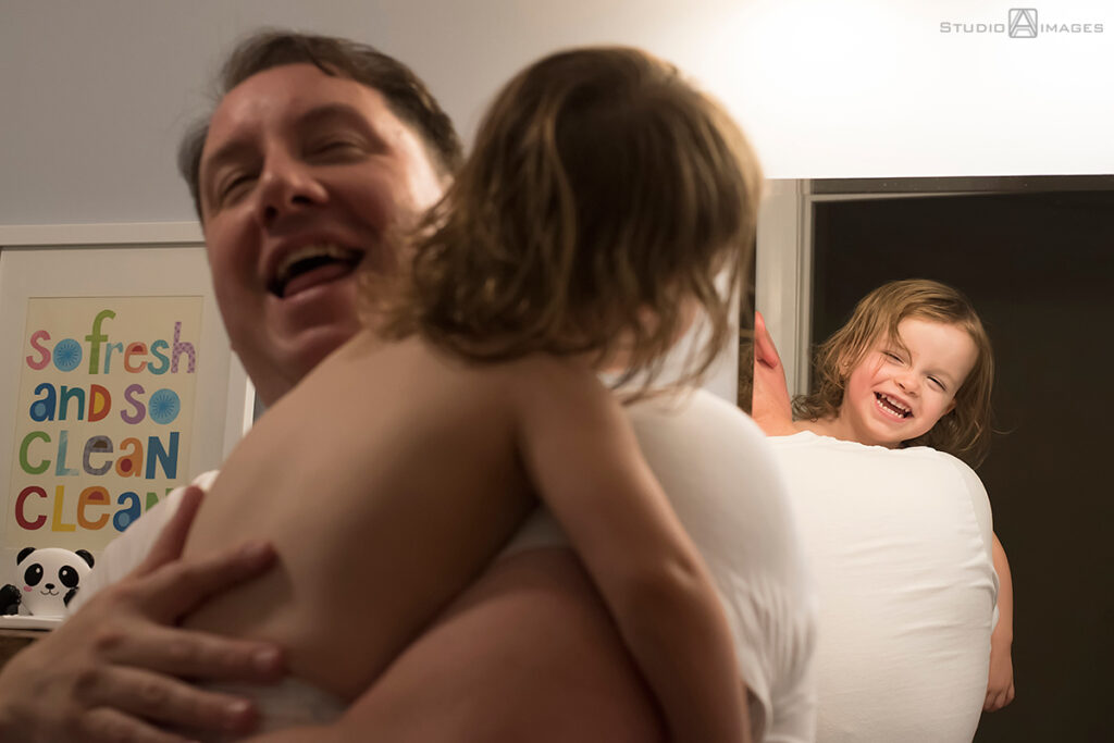 parents and daughter at bath time during their Documentary-style day in the life family photo shoot