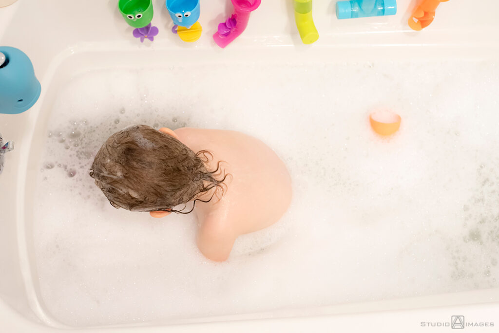 parents and daughter at bath time during their Documentary-style day in the life family photo shoot