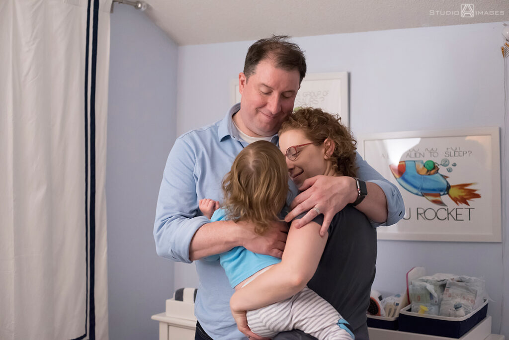 parents and daughter at  bedtime during their Documentary-style day in the life family photo shoot