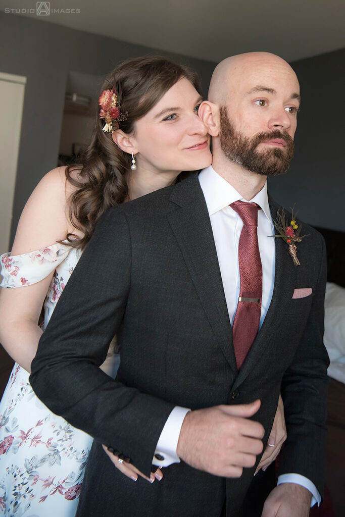 bride and groom getting ready for their wedding in their apt in Jersey City