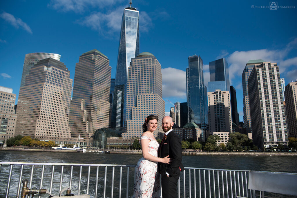 bride and groom posing for portraits on the ferry before their wedding at Liberty House in Jersey City
