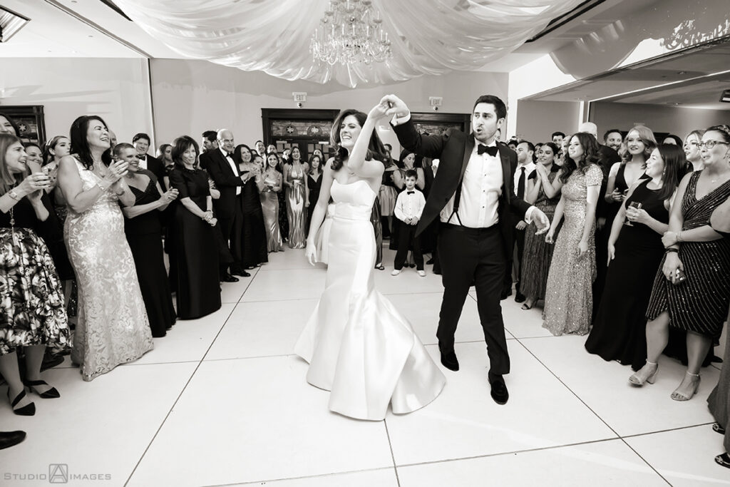 bride and groom enter wedding reception at Temple Emanu-El of Closter