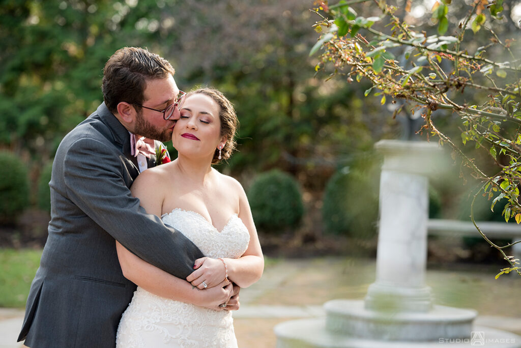 bride and groom embracing on wedding day at Florentine Gardens