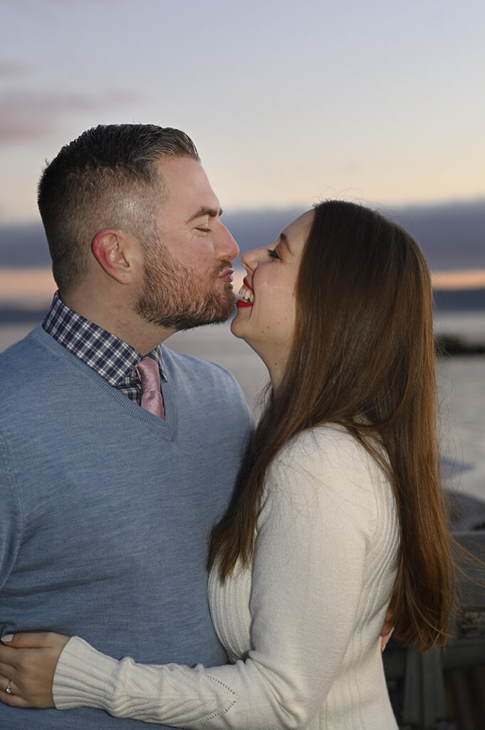 couple making silly face at dawn during their sunrise engagement session in Nyack