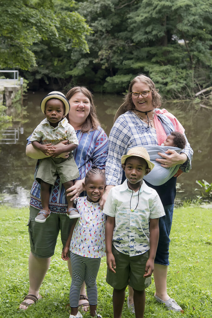 family posing for portrait in the park during their Day in the Life family session in Scarsdale, New York