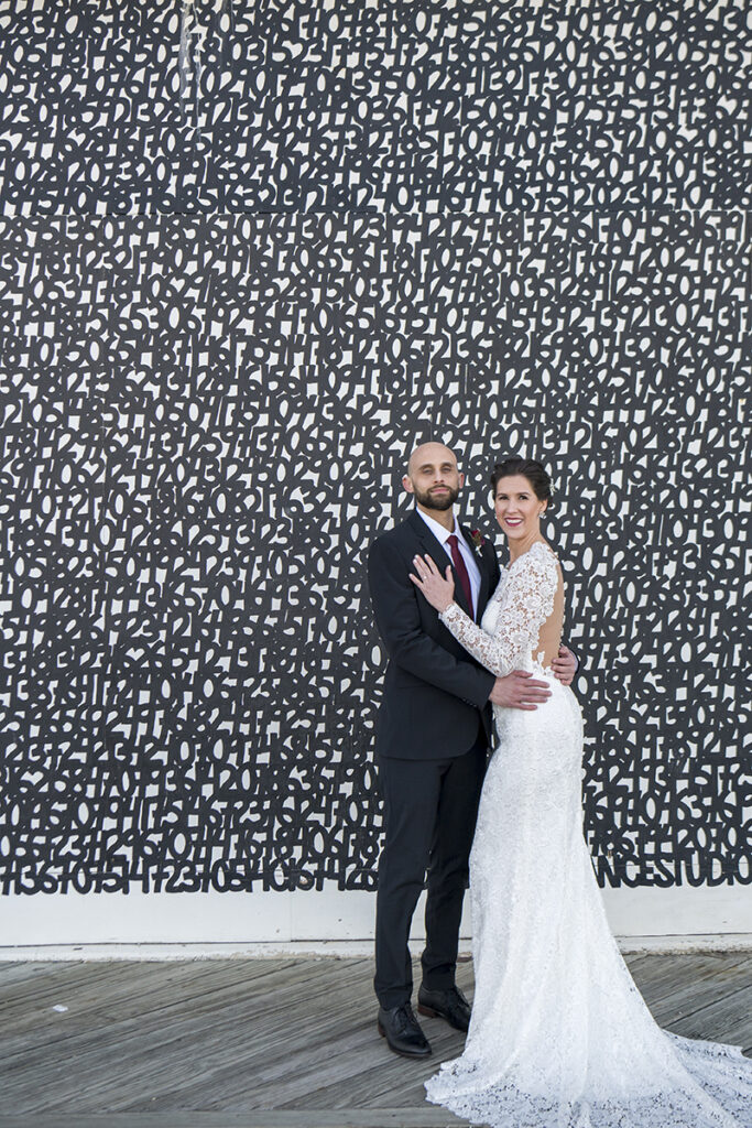 bride and groom in front of Asbury Park murals on their wedding day in Asbury Park.