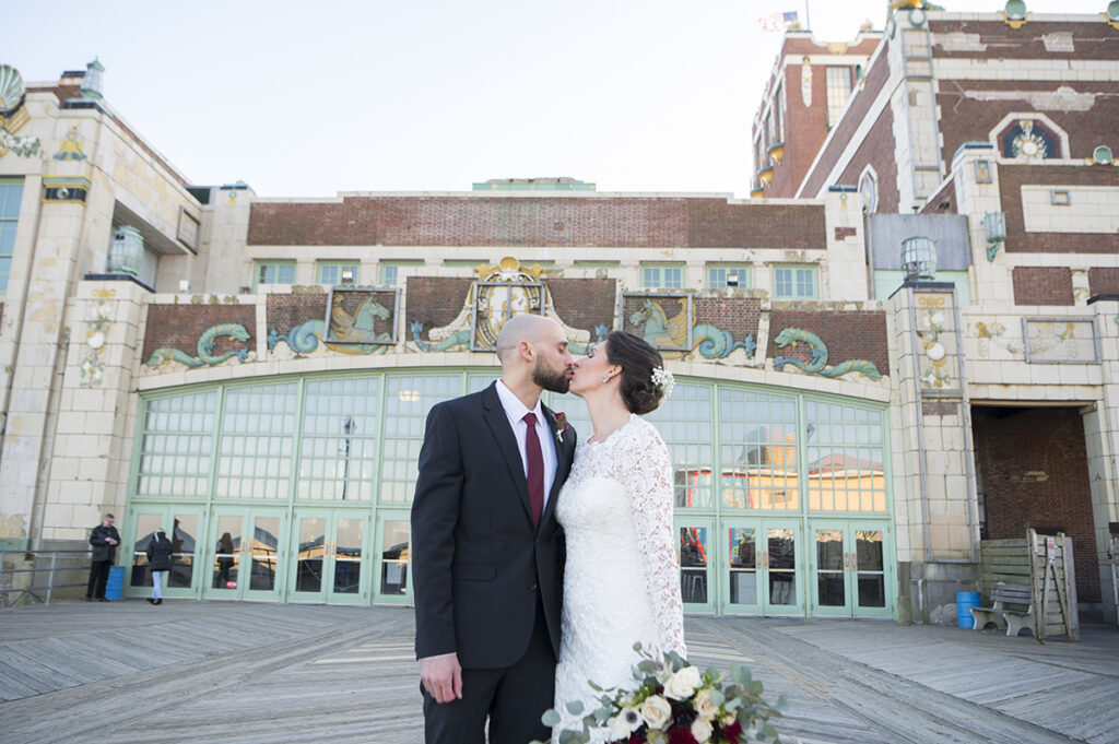 bride and groom in front of Asbury Park Convention Hall on their wedding day in Asbury Park.