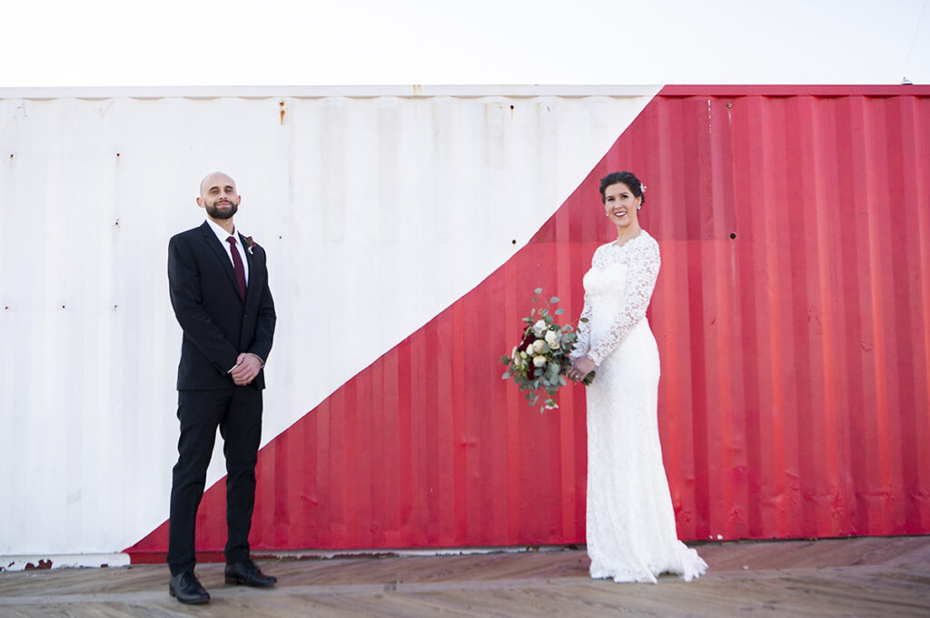 bride and groom in front of Asbury Park murals on their wedding day in Asbury Park.